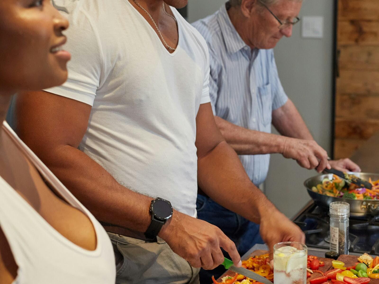 A small group preparing a meal together in a kitchen