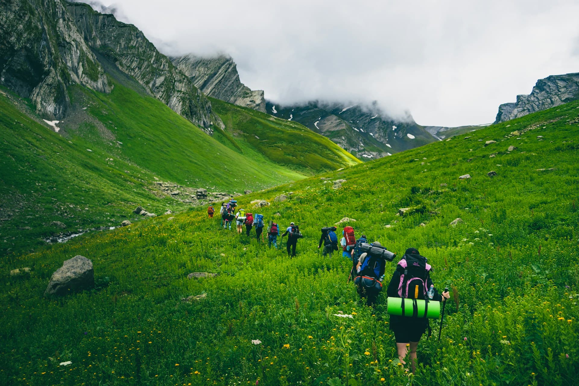 A small group walking together on a mountain trail